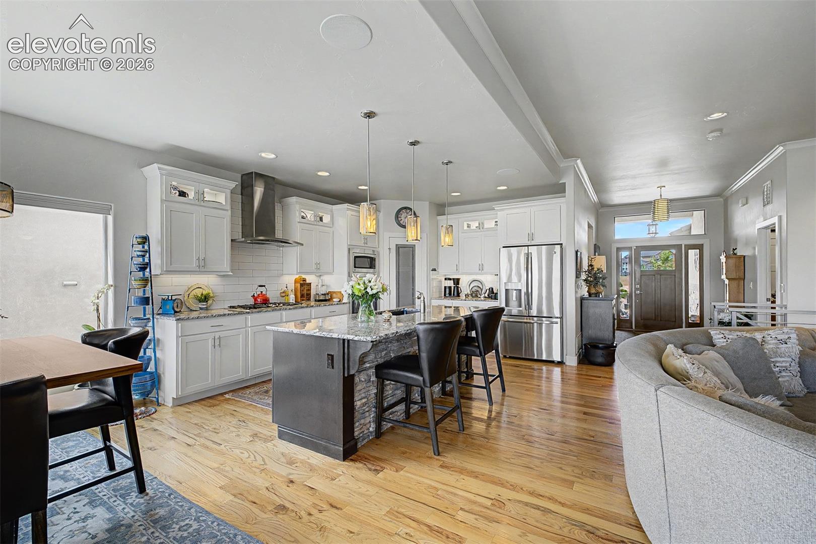 Beautiful kitchen with an 8-foot granite countertop, over and under cabinet lighting, stainless steel appliances, a good-sized pantry and more!