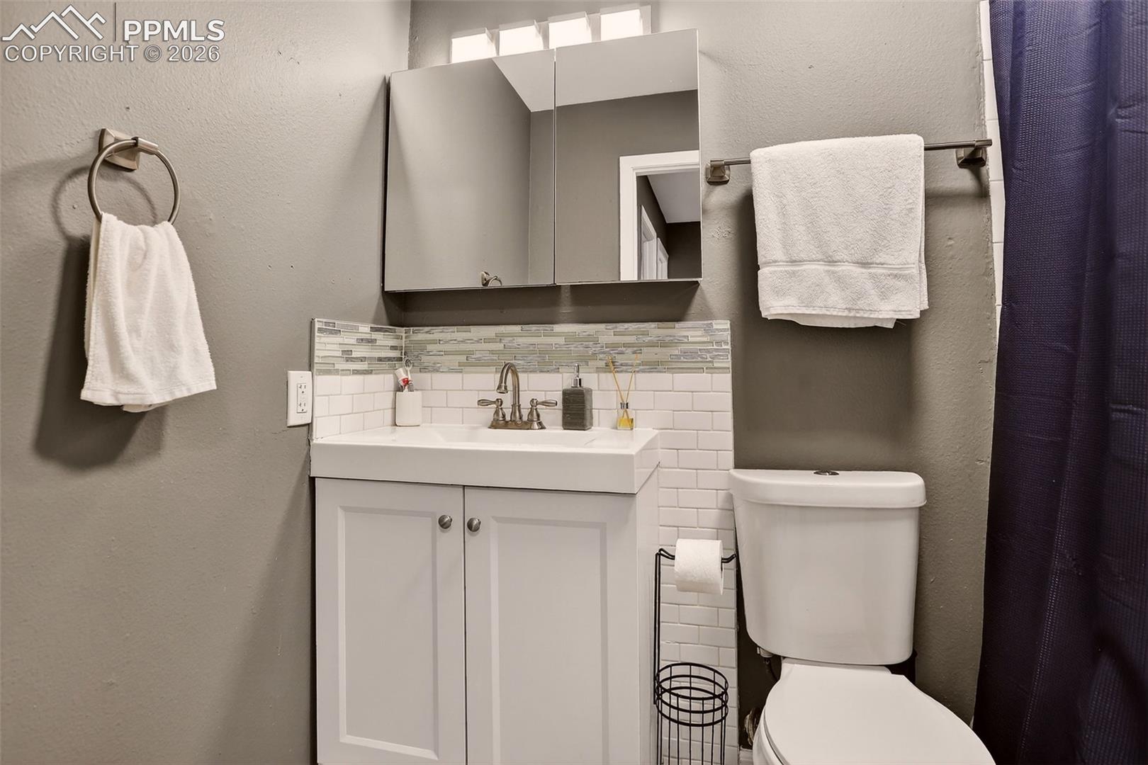 The second bathroom includes an updated vanity and a tub. 