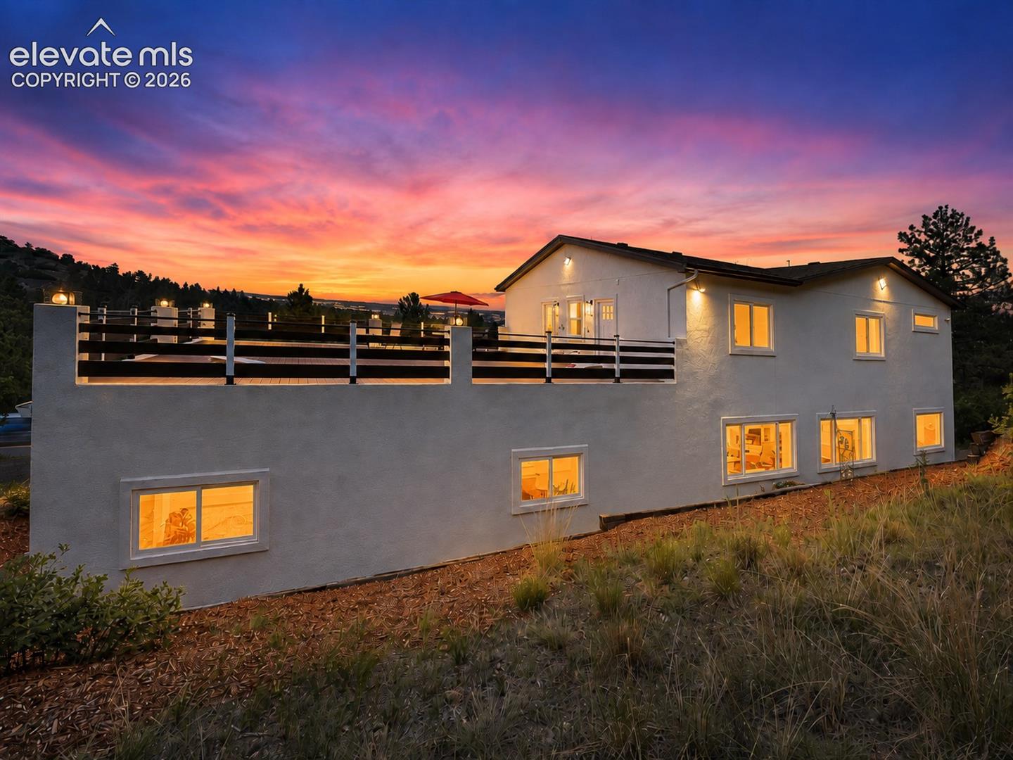 Sunset side view of home and deck.