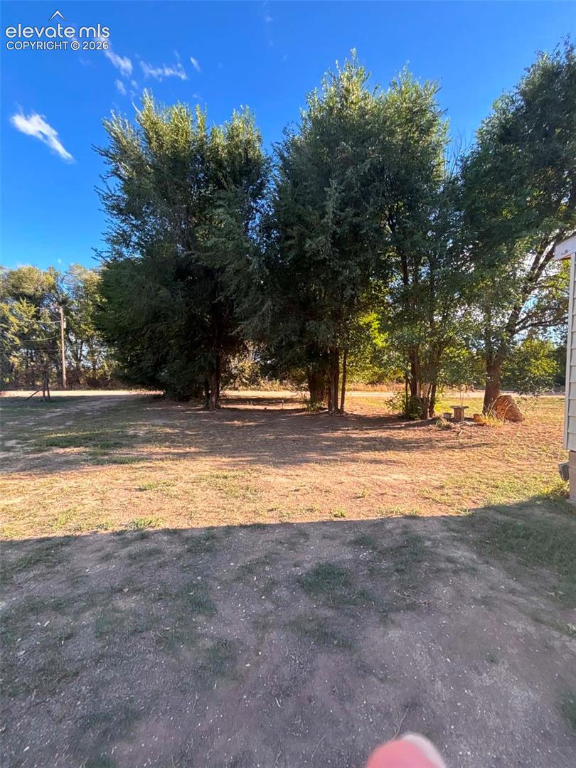Expansive grounds featuring mature trees and open outdoor space