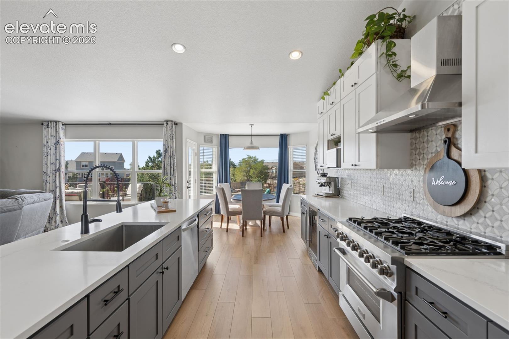 Gourmet kitchen featuring a 36' gas range, stainless steel appliances, and luxury vinyl flooring