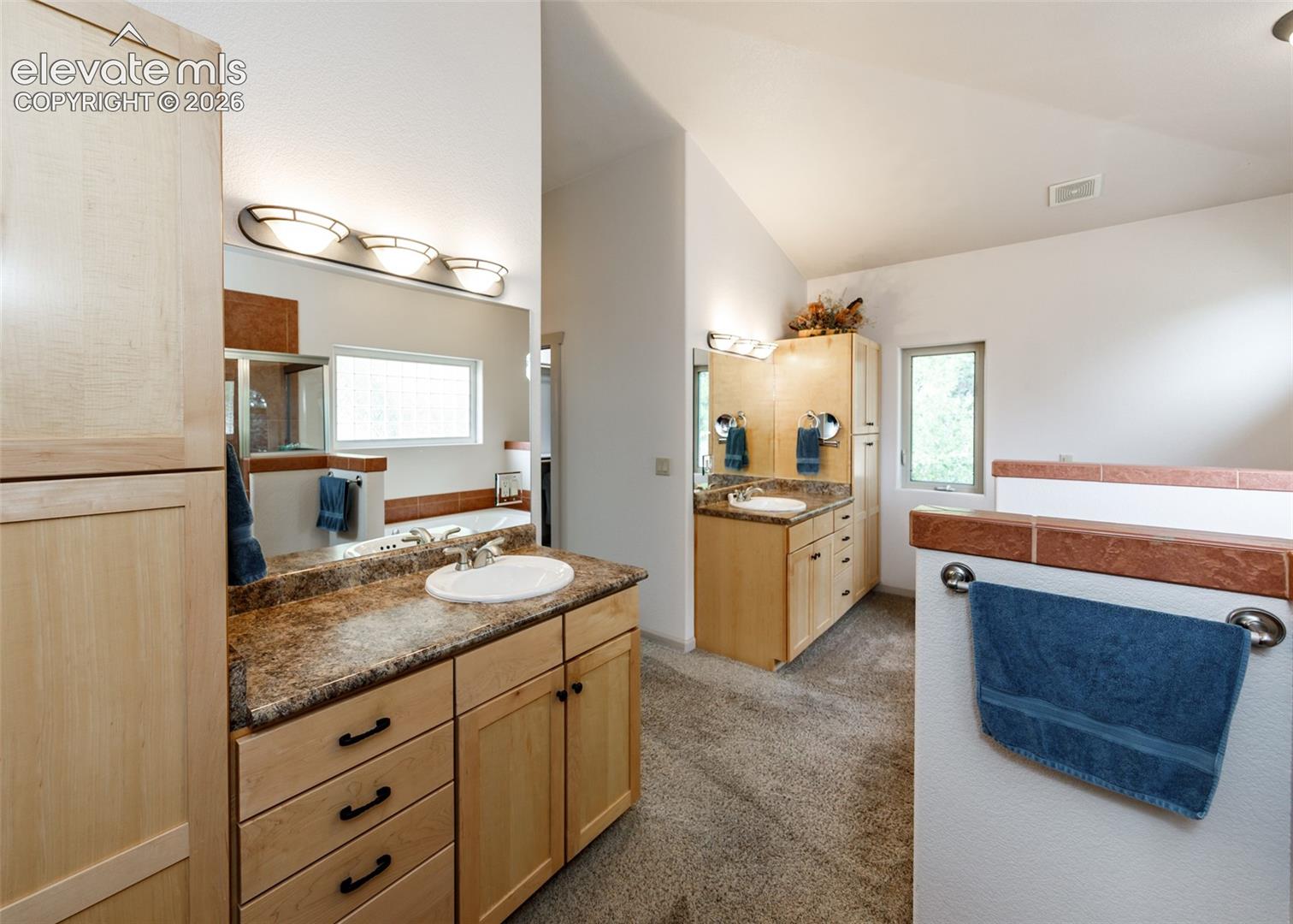Bright 5-piece primary ensuite offers plenty of storage.