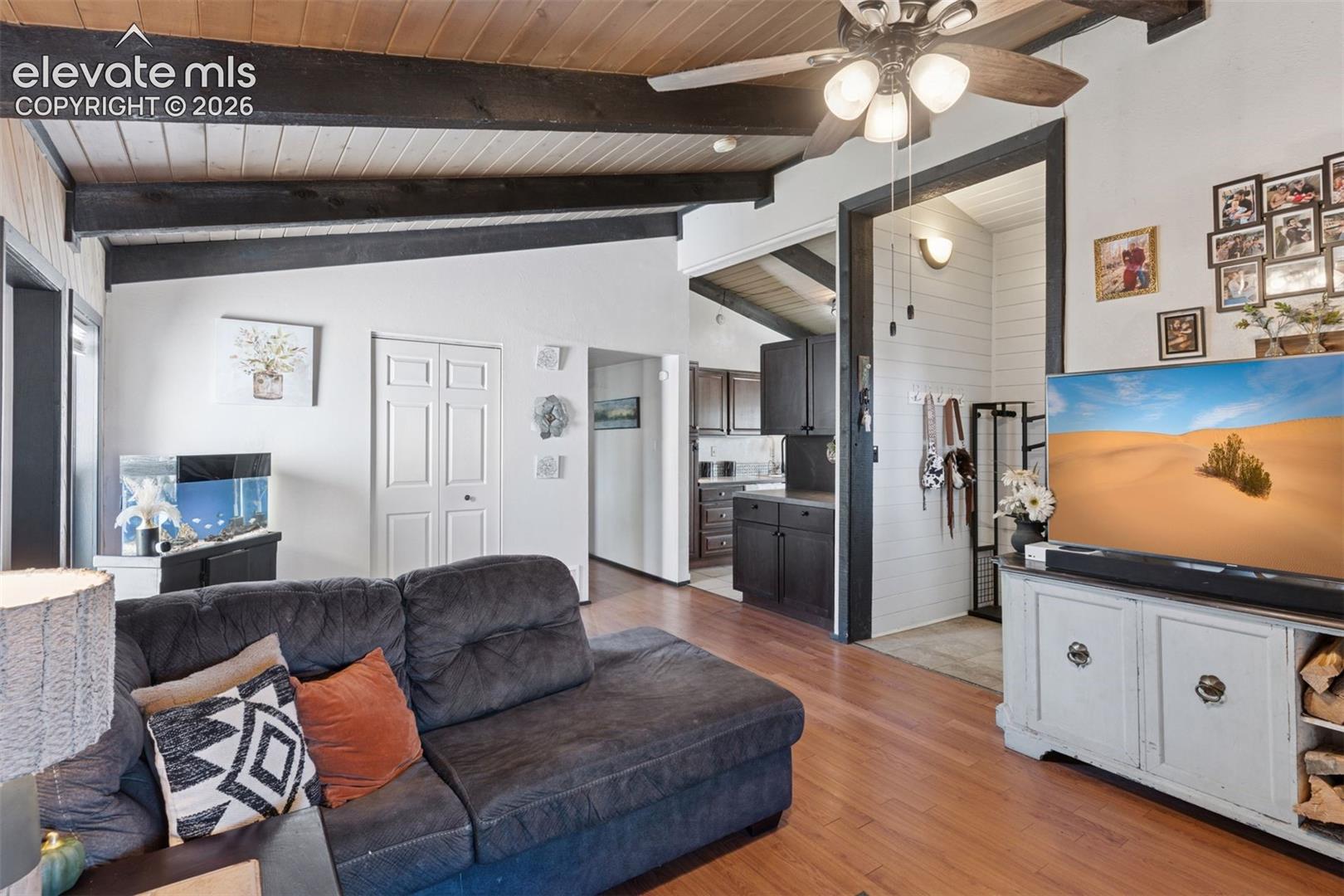 View from living area toward the kitchen and adjacent spaces, highlighting the open flow and functional layout