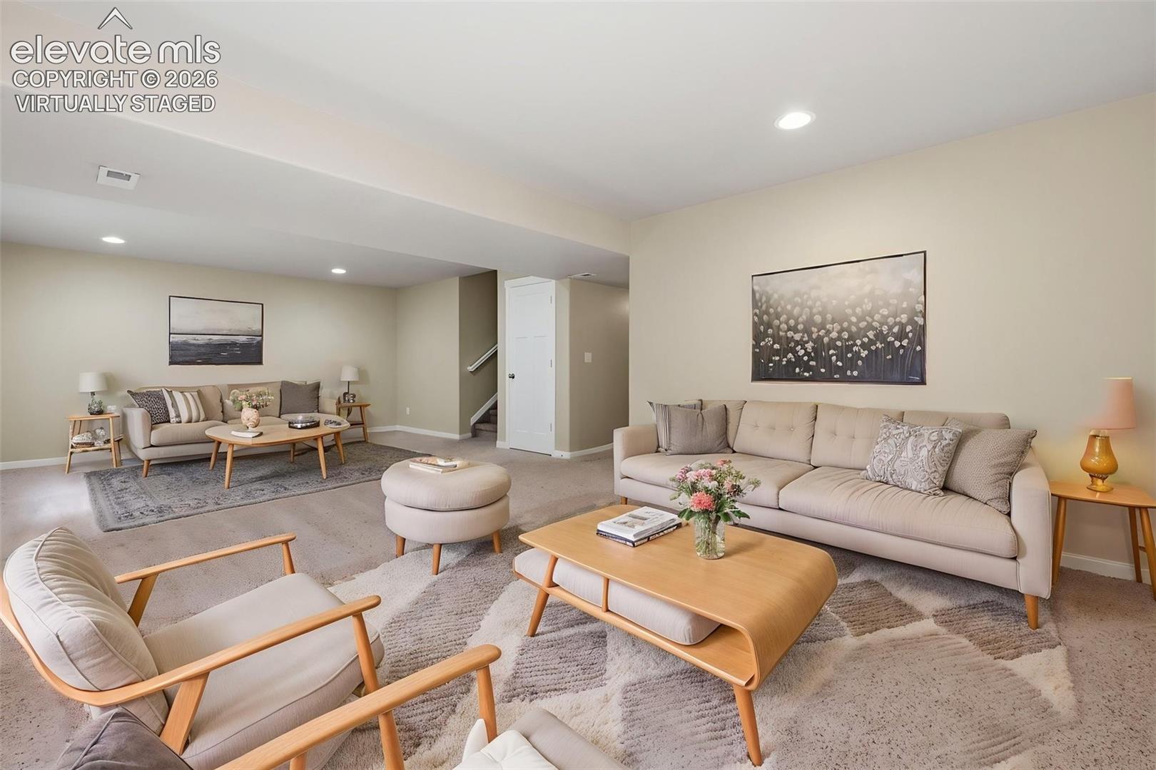Virtually staged to show how the expansive finished basement can accommodate separate media, conversation, gaming or recreation areas.