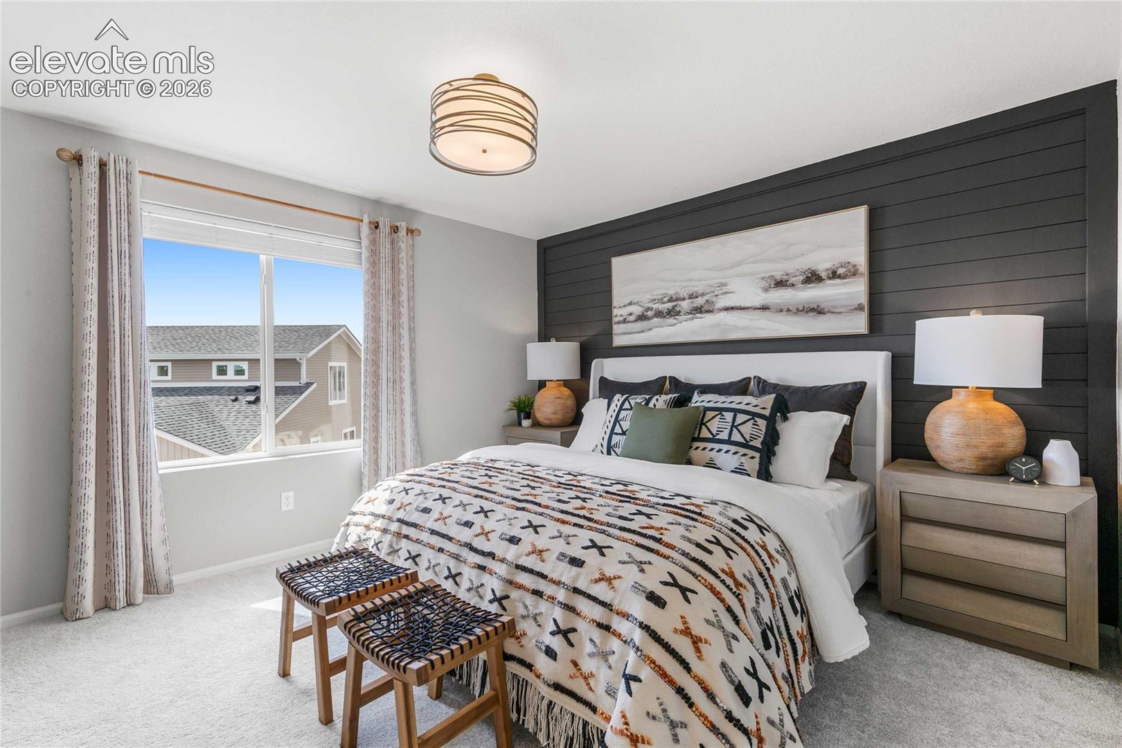 Accent wall with horizontal paneling, wide window, flush mount ceiling light fixture, and light gray wall paint
*photos of a model home*