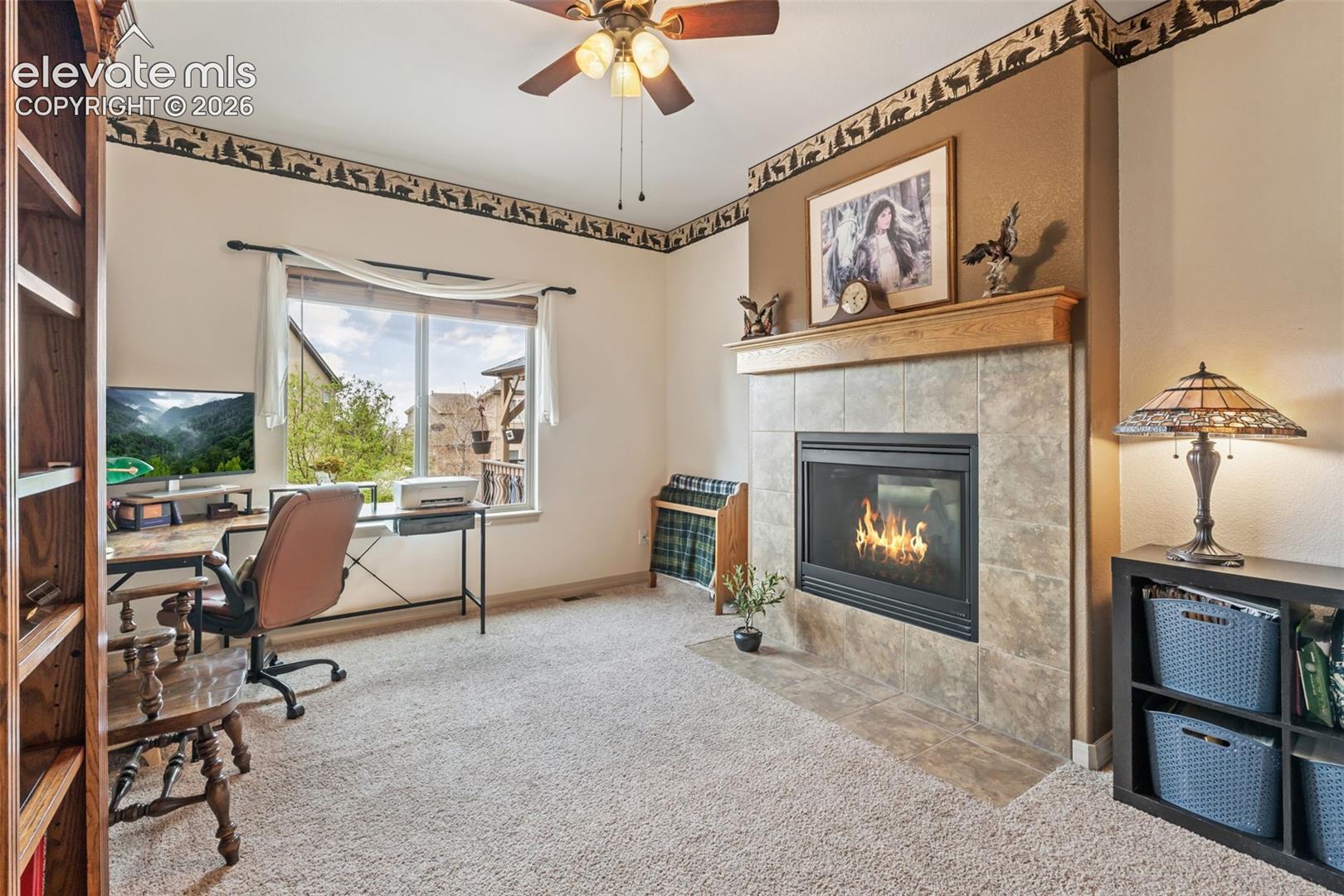 Main level bedroom or office with two way fireplace