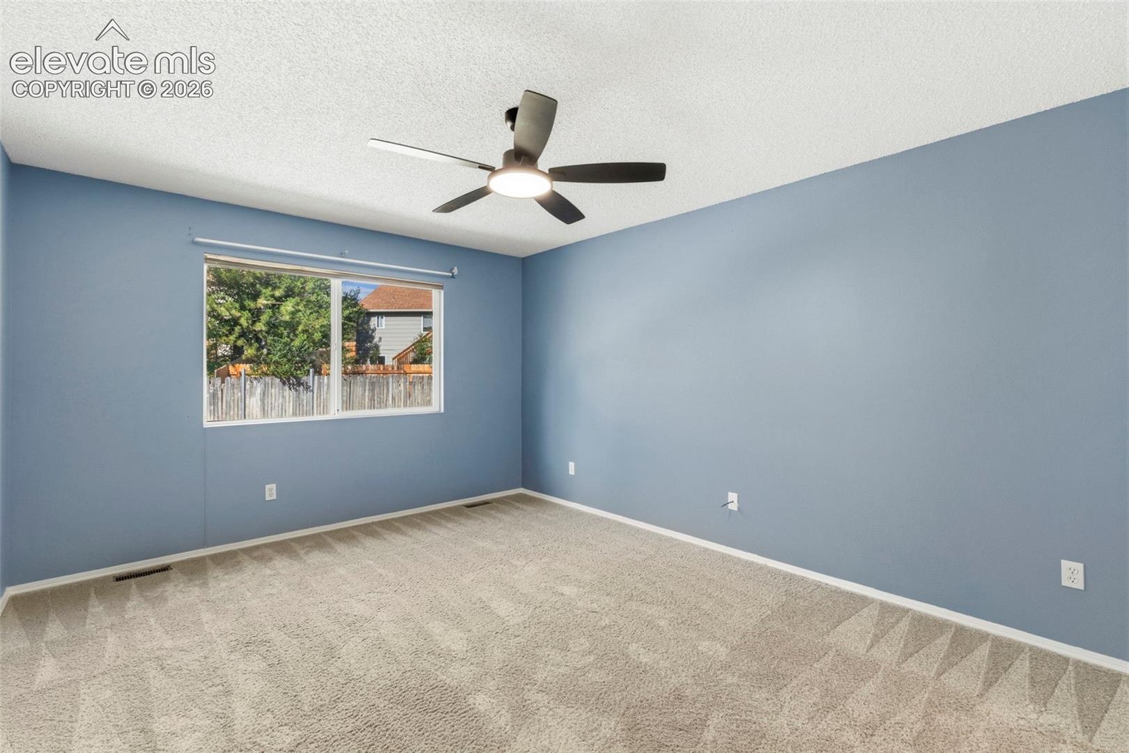 Main level primary bedroom w/ updated ceiling fan!