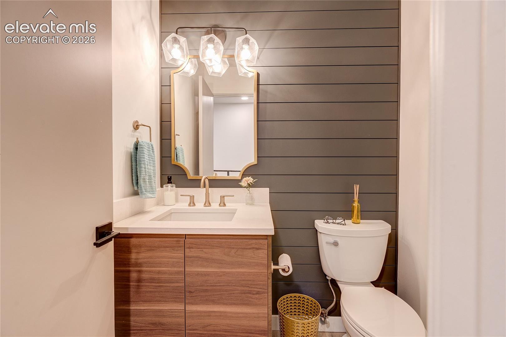 Wood-finish vanity with an undermount sink and light-toned countertop