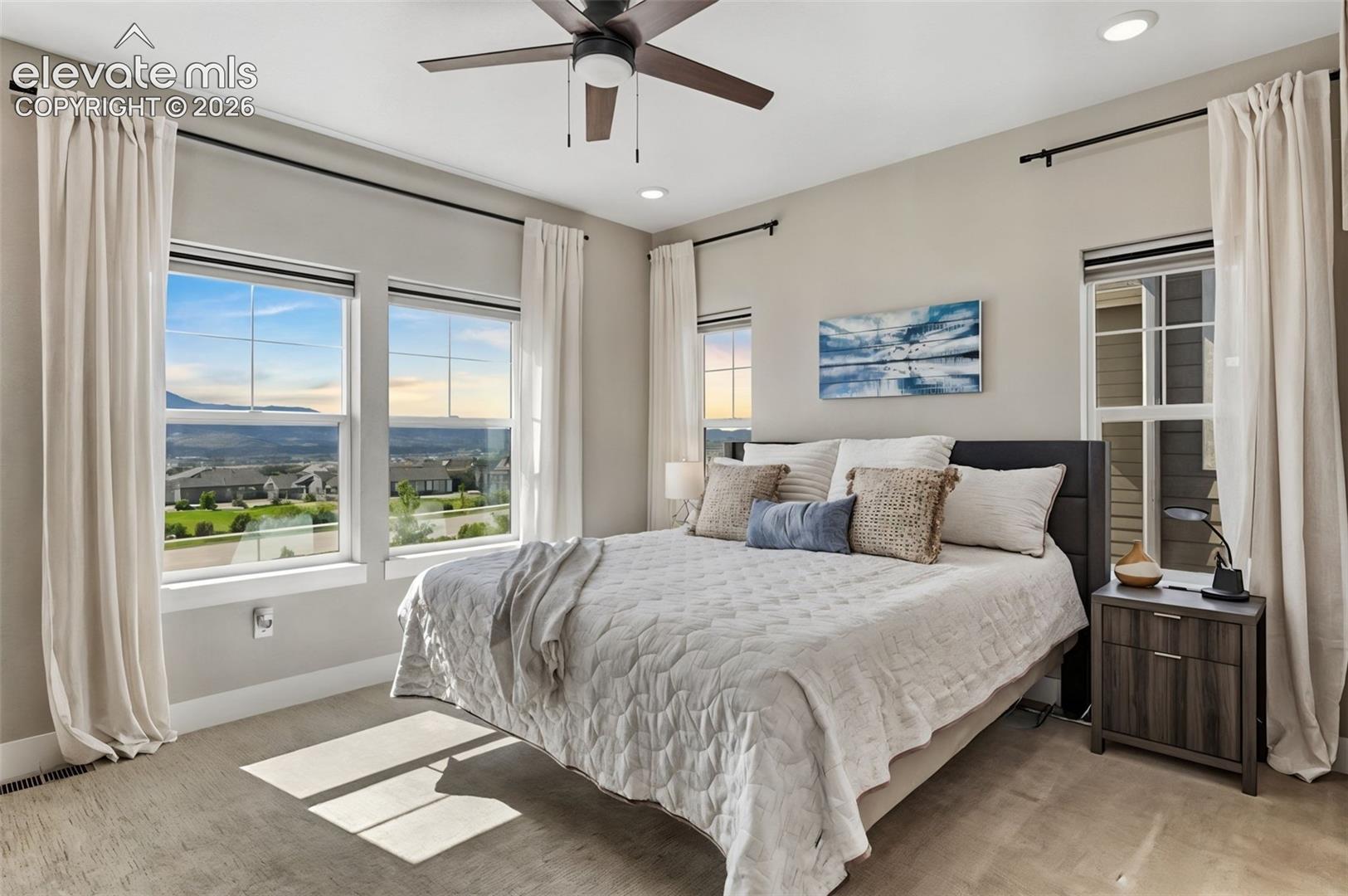 Primary bedroom w/ windows that let you see that picturesque mountain view the minute you open your eyes