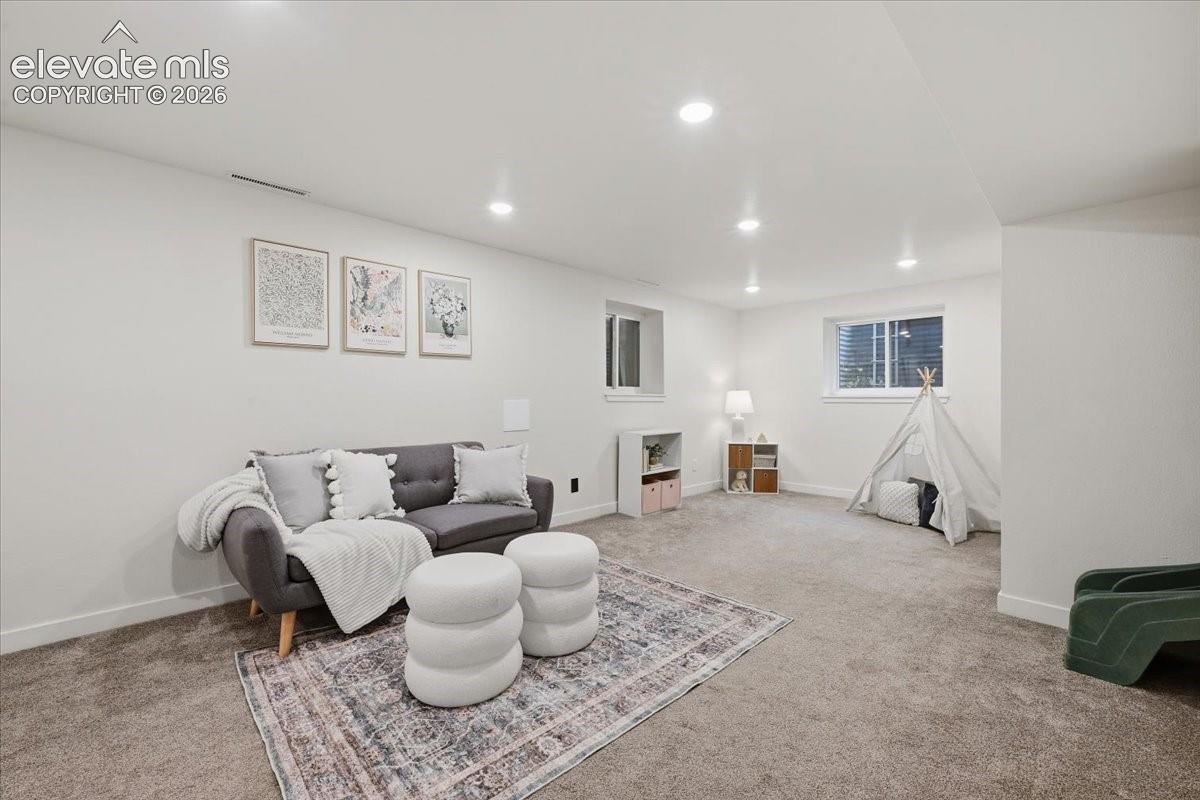 Spacious room with recessed lighting, carpet flooring, and white walls
