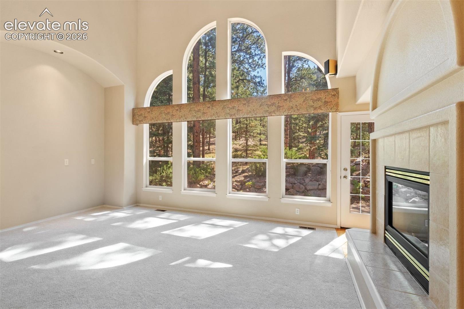 Family room with dual sided fireplace and wall of windows
