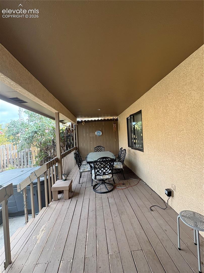 Covered outdoor deck with wood-finish flooring