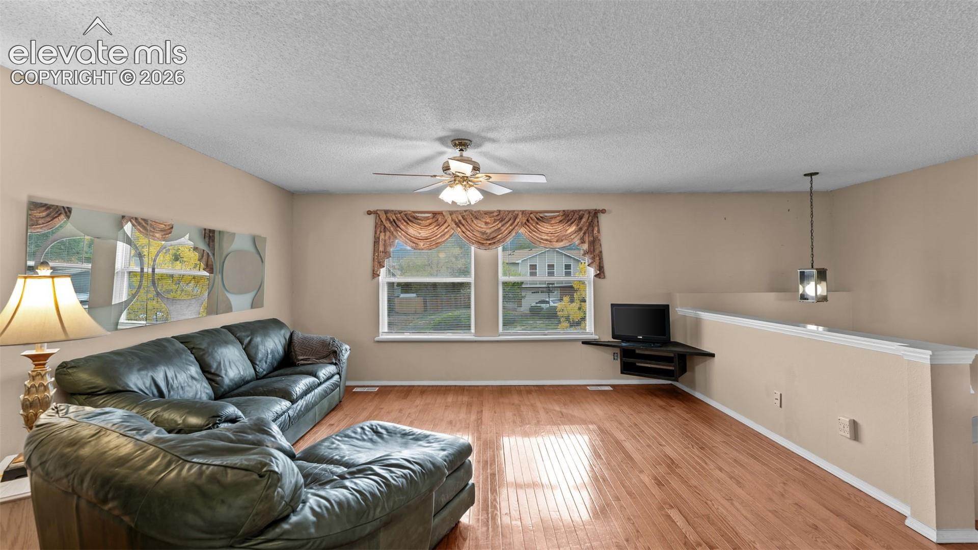 On the upper level, at the top of the stairs, find a large living room