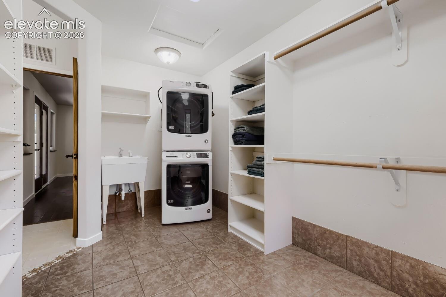 Primary closet with own laundry and sink