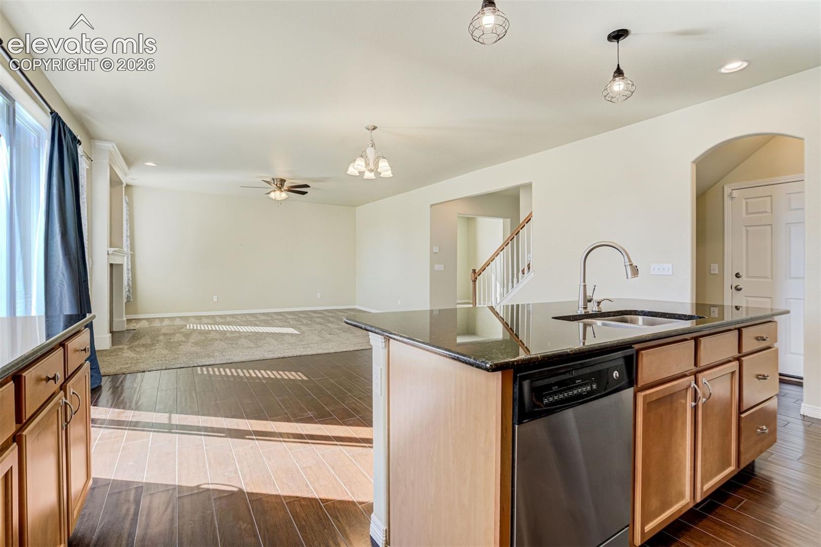 Kitchen island with an undermount sink, gooseneck faucet, and integrated dishwasher