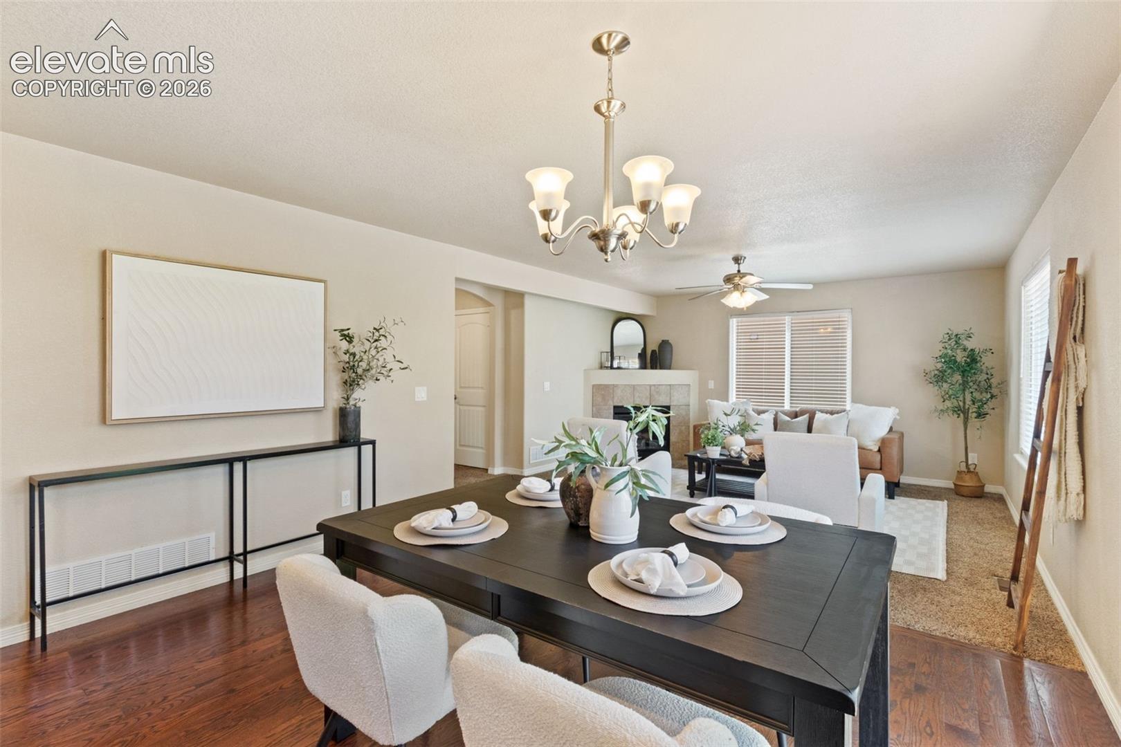 Dining area with wood-finish flooring featuring a multi-light chandelier