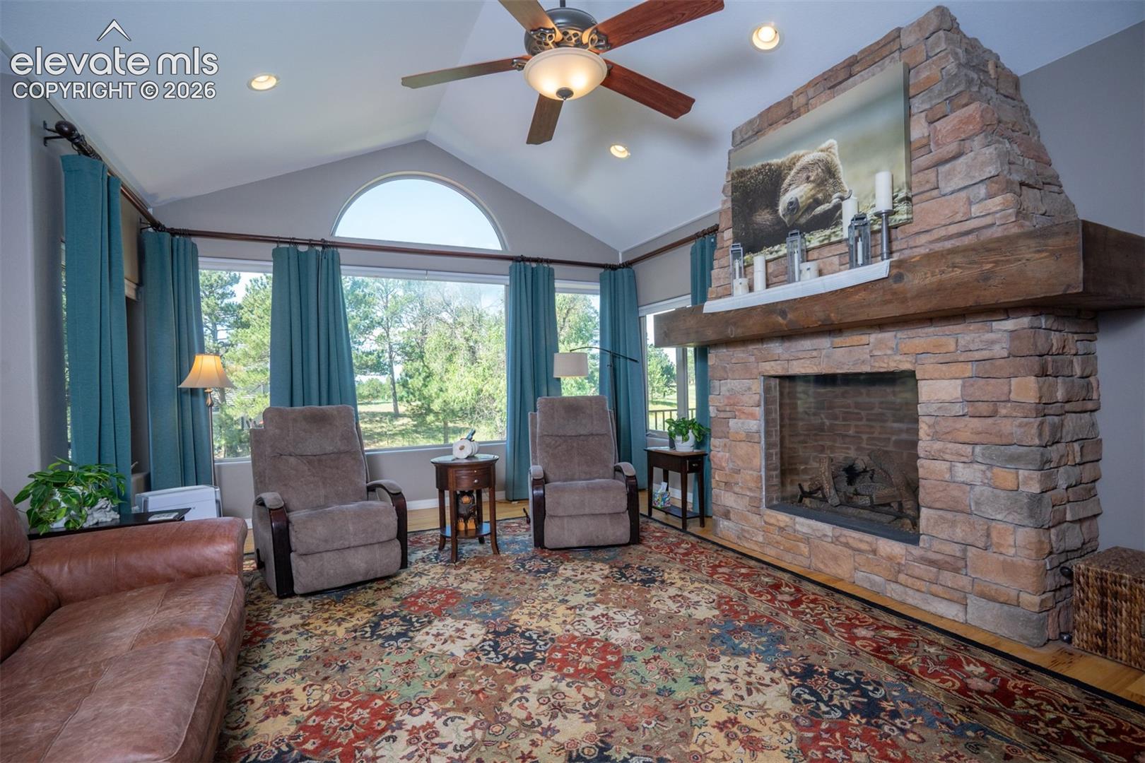 A fabulous stone gas fireplace with mantle gives this room the mountain character deserving of this modern mountain home with plenty of nat'l light spilling in.