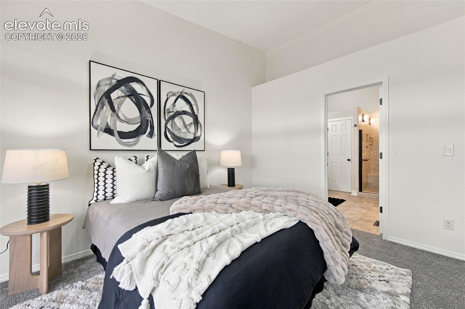 Neutral-toned interior featuring wall-to-wall carpeting and interior doorway access