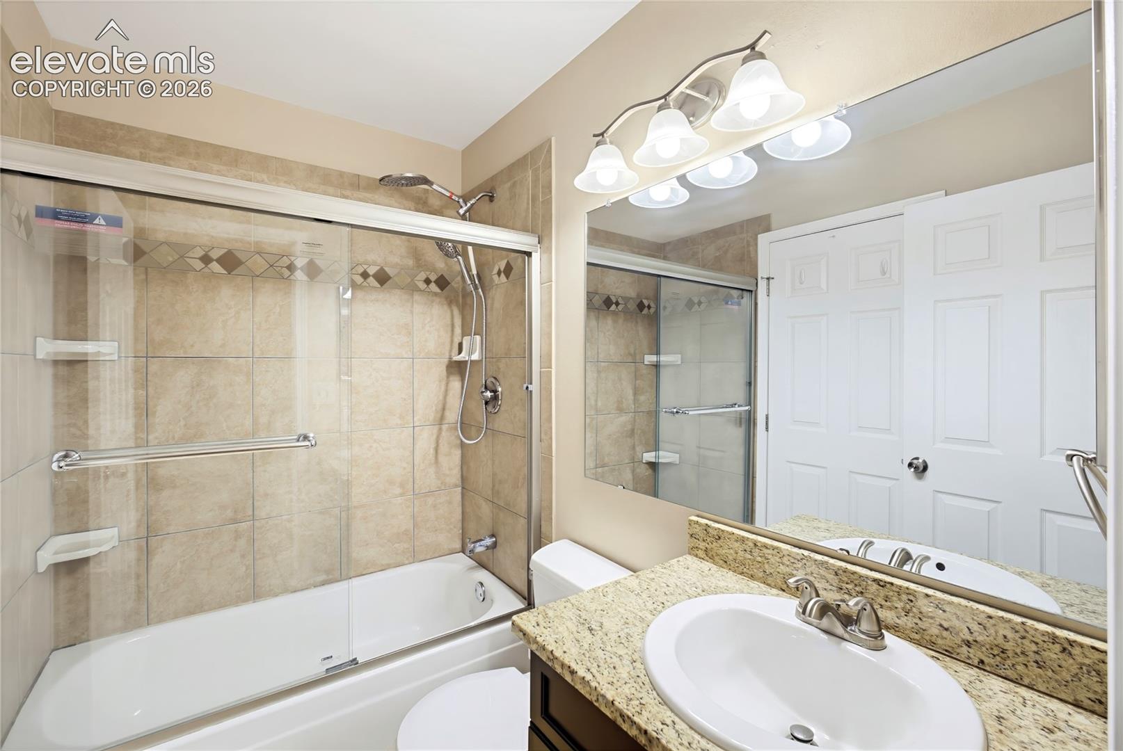 Upper Level Bathroom  includes a vanity, mirror, and tiled tub/shower
