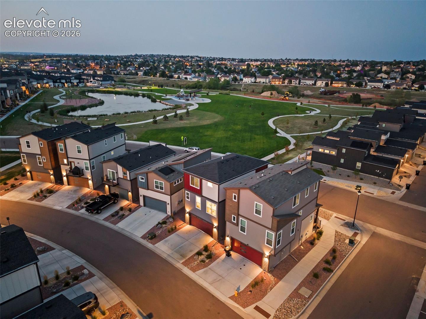 This home (second to the left in this view) has a rear-facing garage and driveway. 