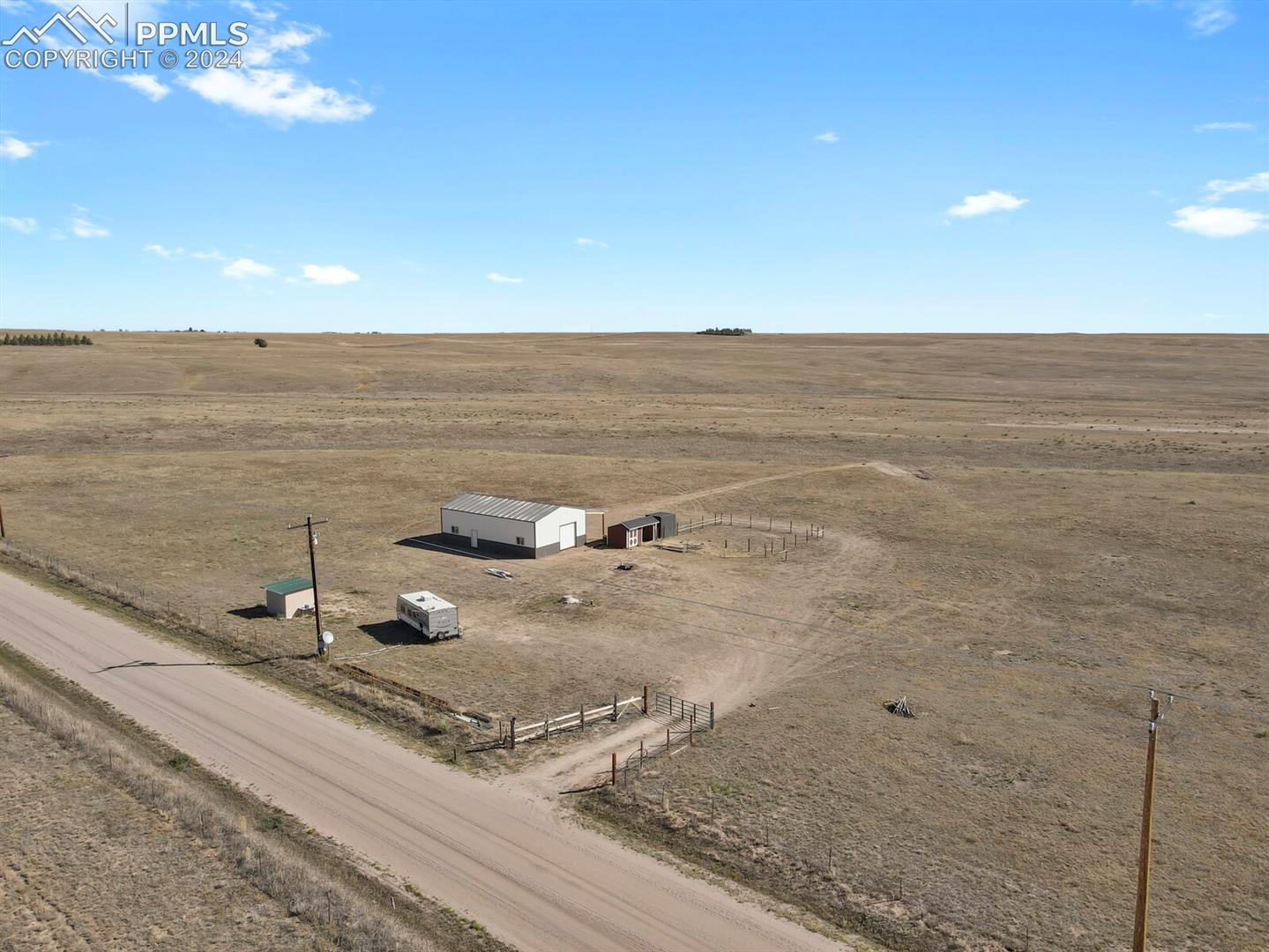 Expansive aerial view showing the scale and openness of the property