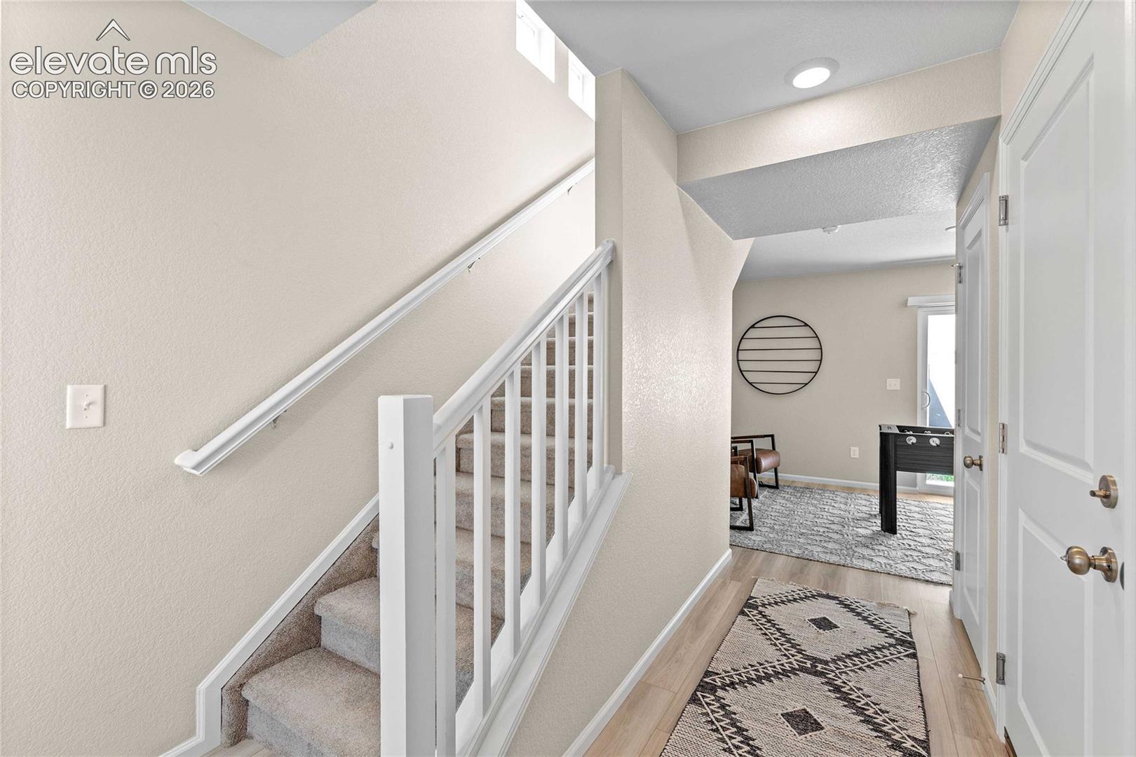 Staircase featuring a white handrail and carpeted treads
*photos of a model home*
