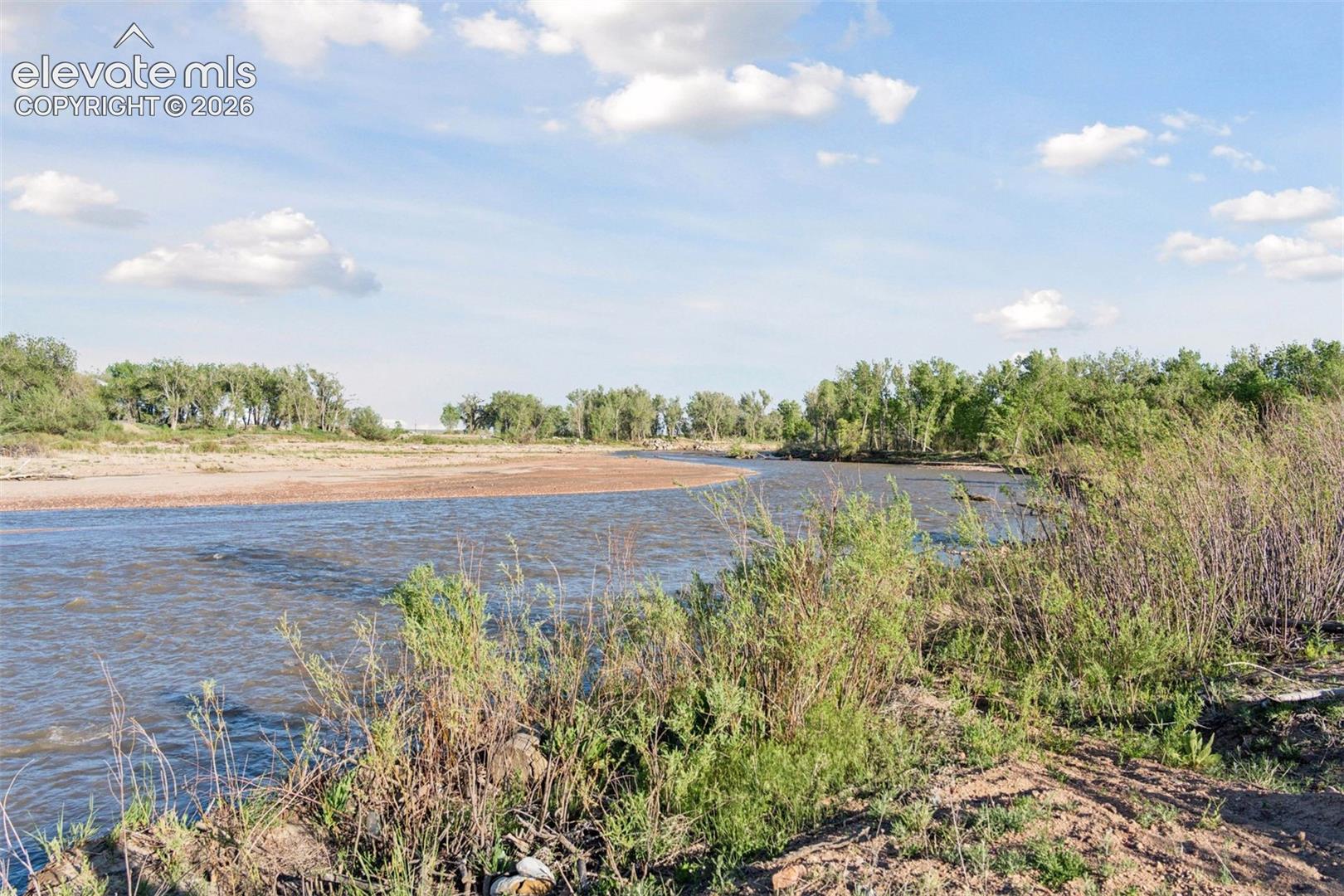 Peaceful creekside views where open water, sandy banks, and riparian habitat meet