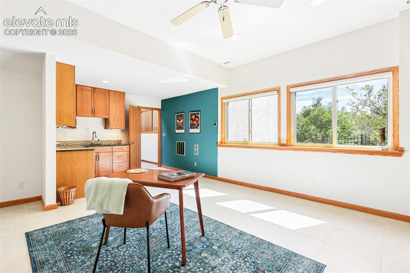 Large expansive office/studio with radiant heated flooring, wet bar, and custom cabinet built-ins.
