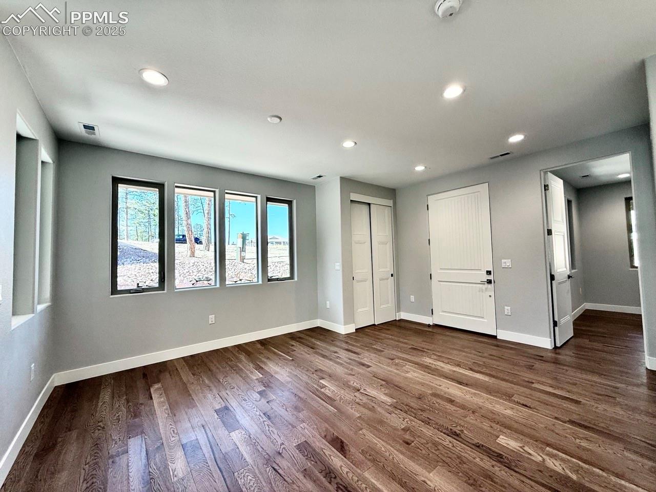 Dining Room with Wood Flooring and Large Windows.