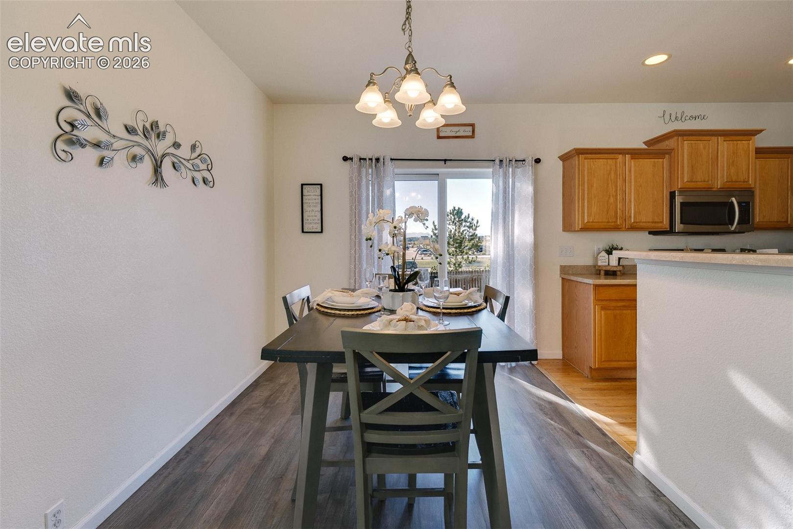 Wood-finish flooring throughout, with a sliding glass door providing access to the outdoors