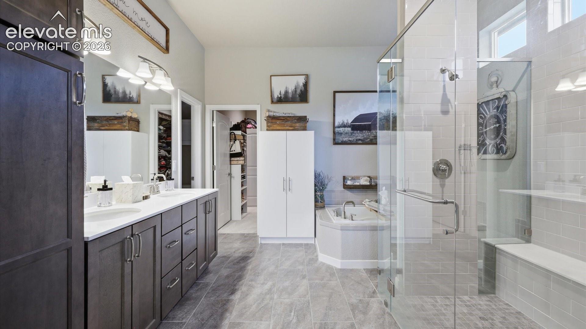 LUXURY DESIGNED AROUND YOU — The spa-inspired primary bath flows into an oversized walk-in closet with direct access to the laundry room—an exceptional design that makes everyday living effortlessly luxurious.