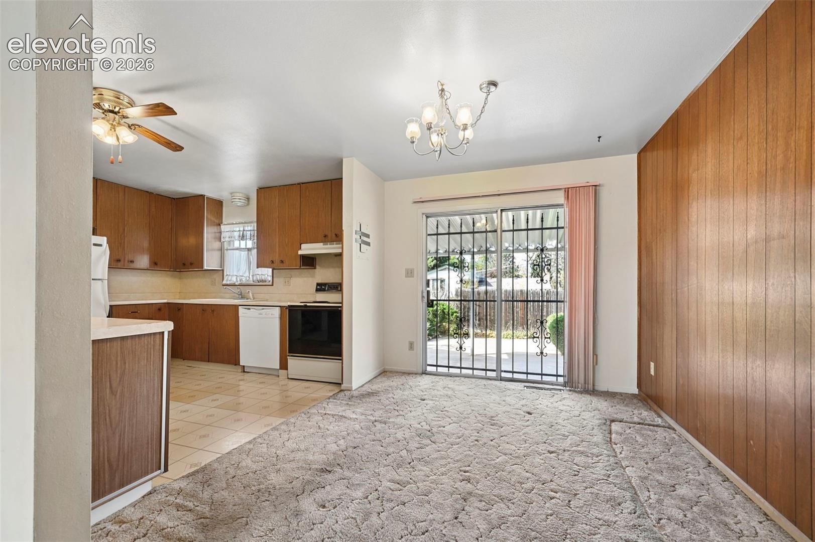 Kitchen featuring wood cabinetry, integrated dishwasher, and range, and refrigerator