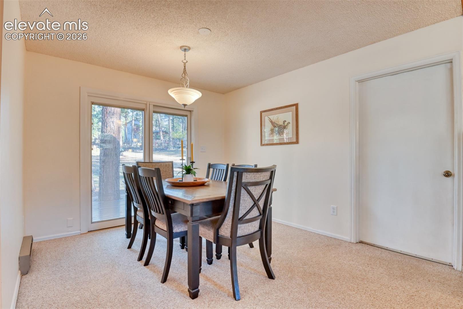 Dining room has slider door to walk-out to back deck. Other door on the right leads to the oversized two car attached garage. 