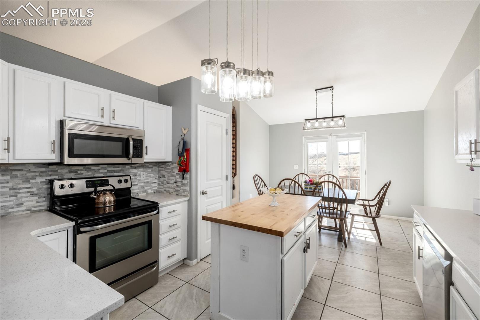 Updated Kitchen with beautiful white cabinetry and quartz/butcher block countertops