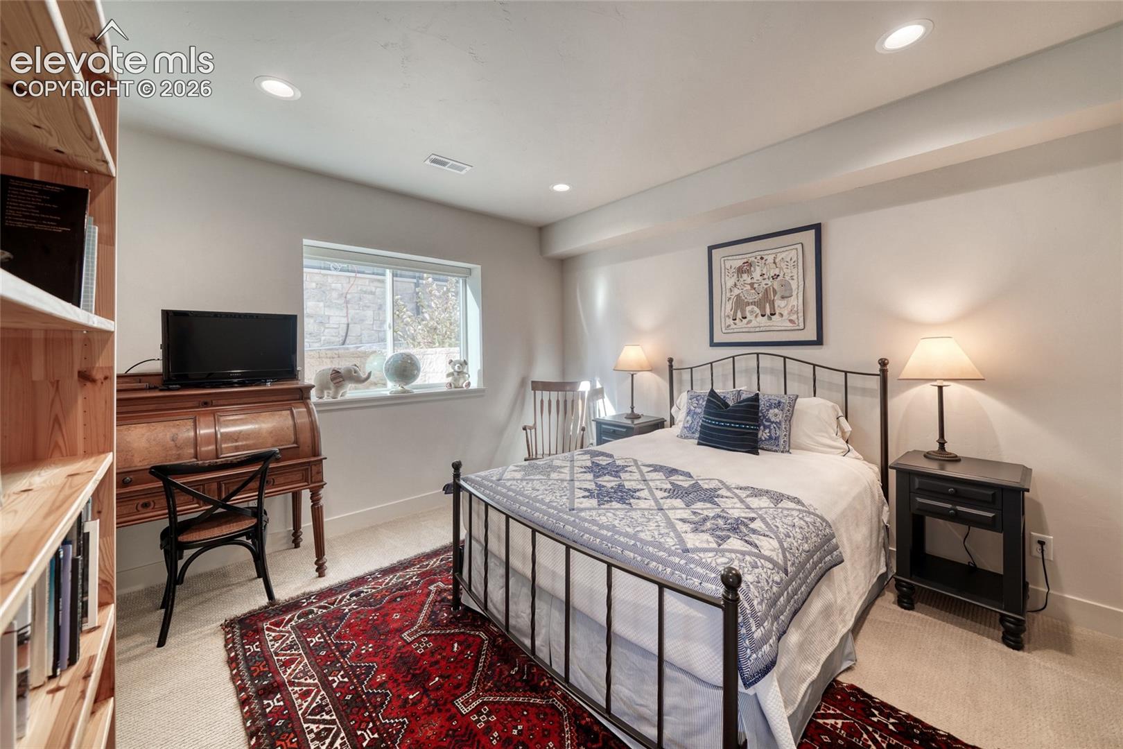 Neutral-toned room featuring recessed ceiling lighting, a wide window with a stone sill, and wall-to-wall carpeting