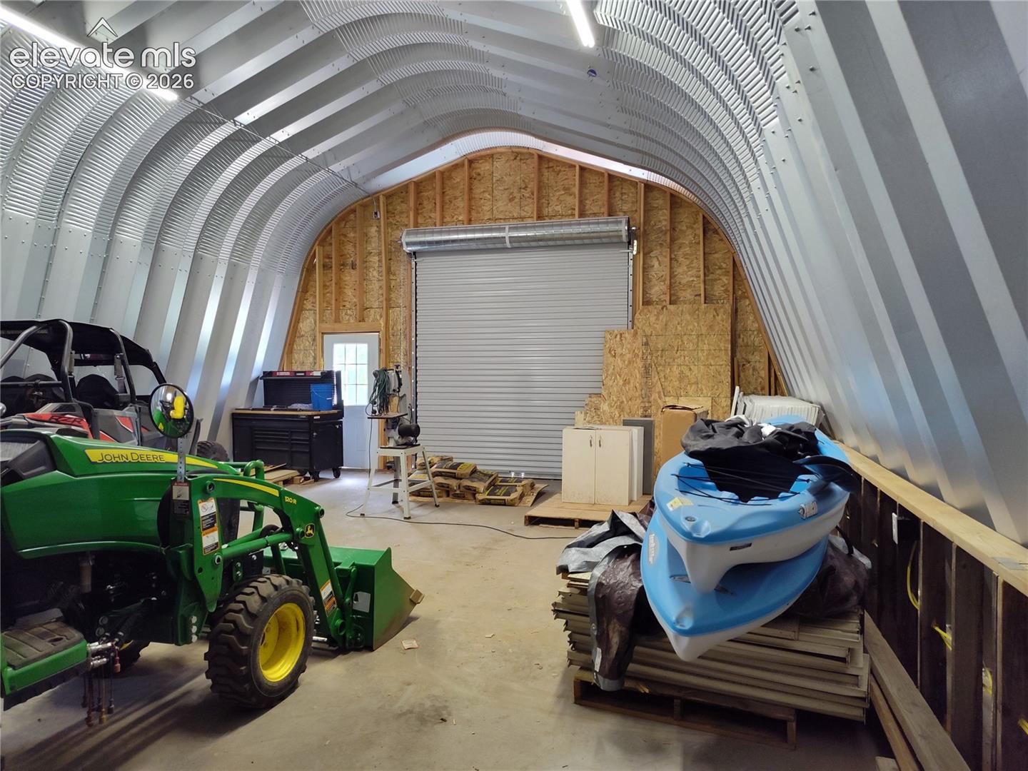 Electric, Mandoor exits and roll up doors on both side. 