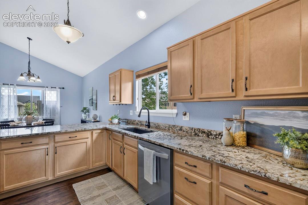 Kitchen featuring light-finish cabinetry, stone-look countertops, a dark-finish faucet with a dual-basin sink, vaulted ceilings, and recessed lighting