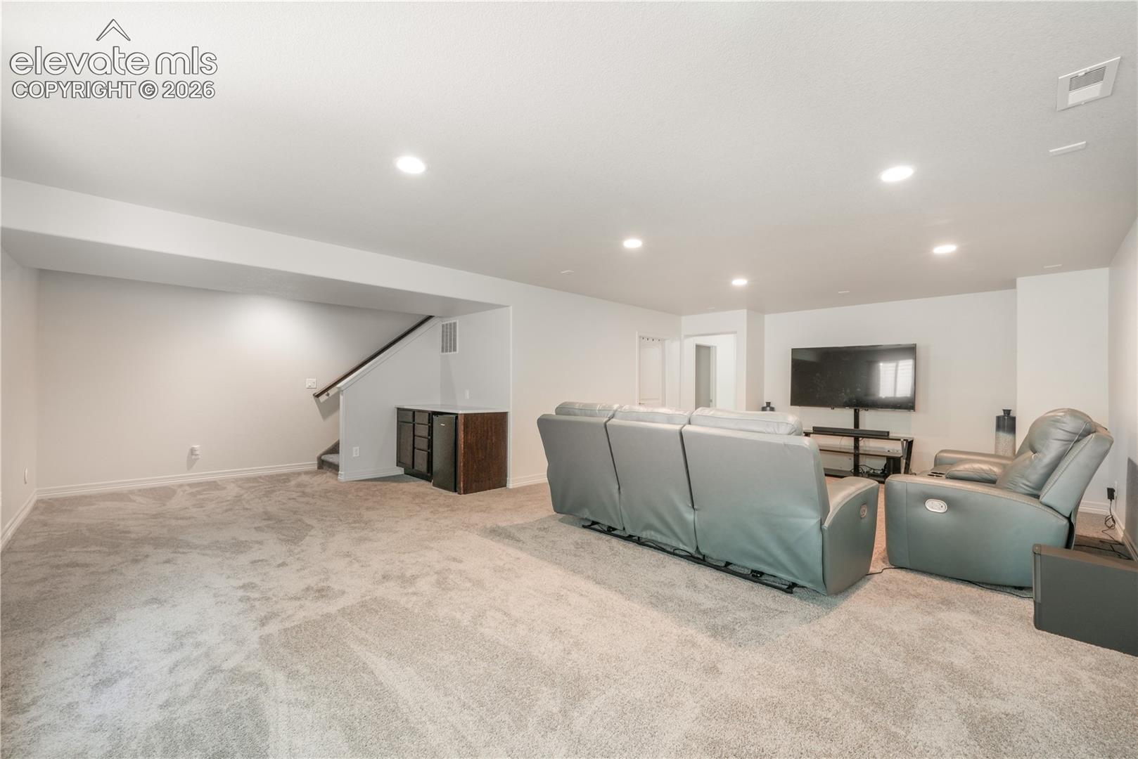 Basement family room with mini wet bar, new carpet