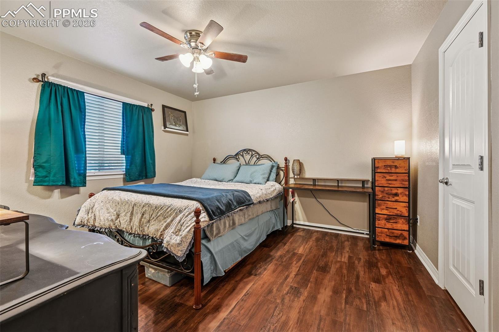 Bedroom featuring dark wood finished floors and a ceiling fan