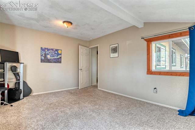Unfurnished bedroom featuring baseboards and carpet