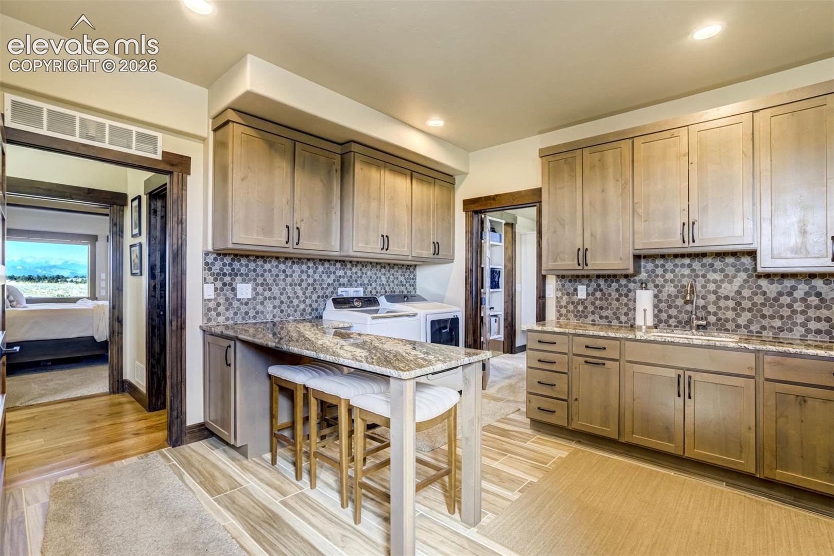 Laundry/Mudroom with direct access to master closet and garage