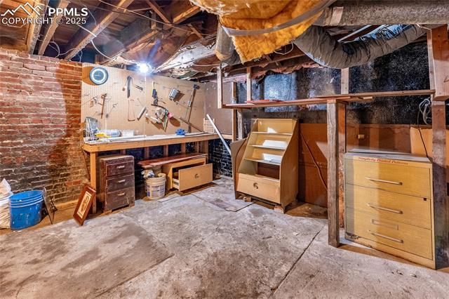 Unfinished basement with a workshop area