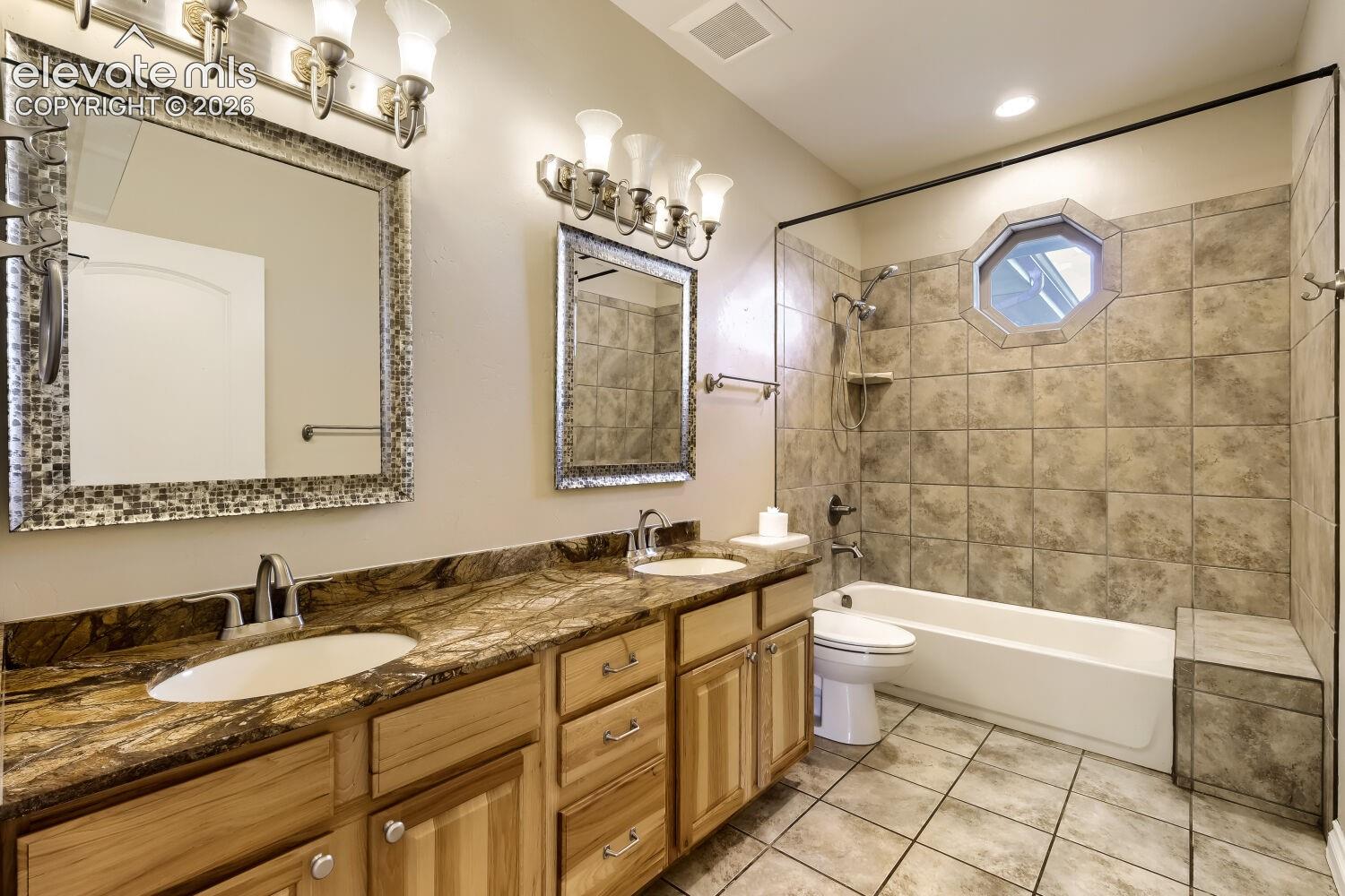 Observe the double sinks in this main floor guest bathroom with more natural light. 