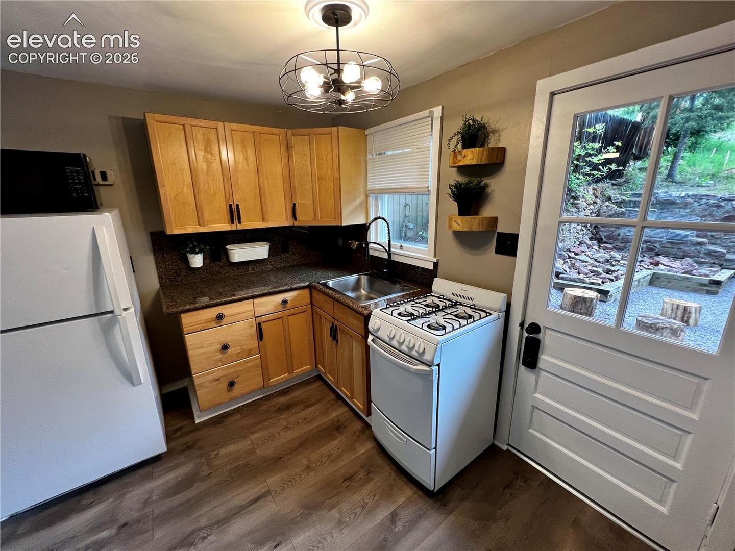 Upper Apt: Nice kitchen with gas stove. View to rear patio with fire pit