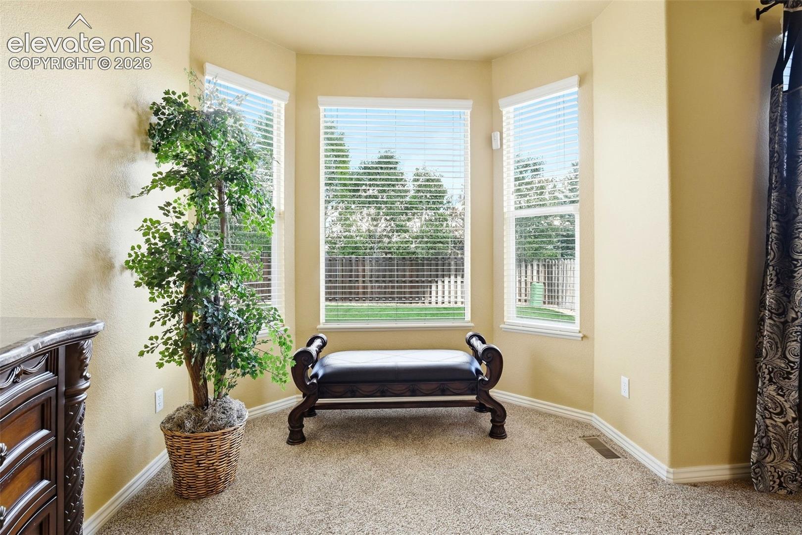 The bay window bump creates a cozy spot to unwind.  Just one of the thoughtful touches in this primary suite.