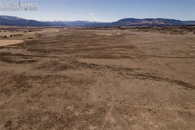 View of mountain backdrop with a desert landscape and rural landscape