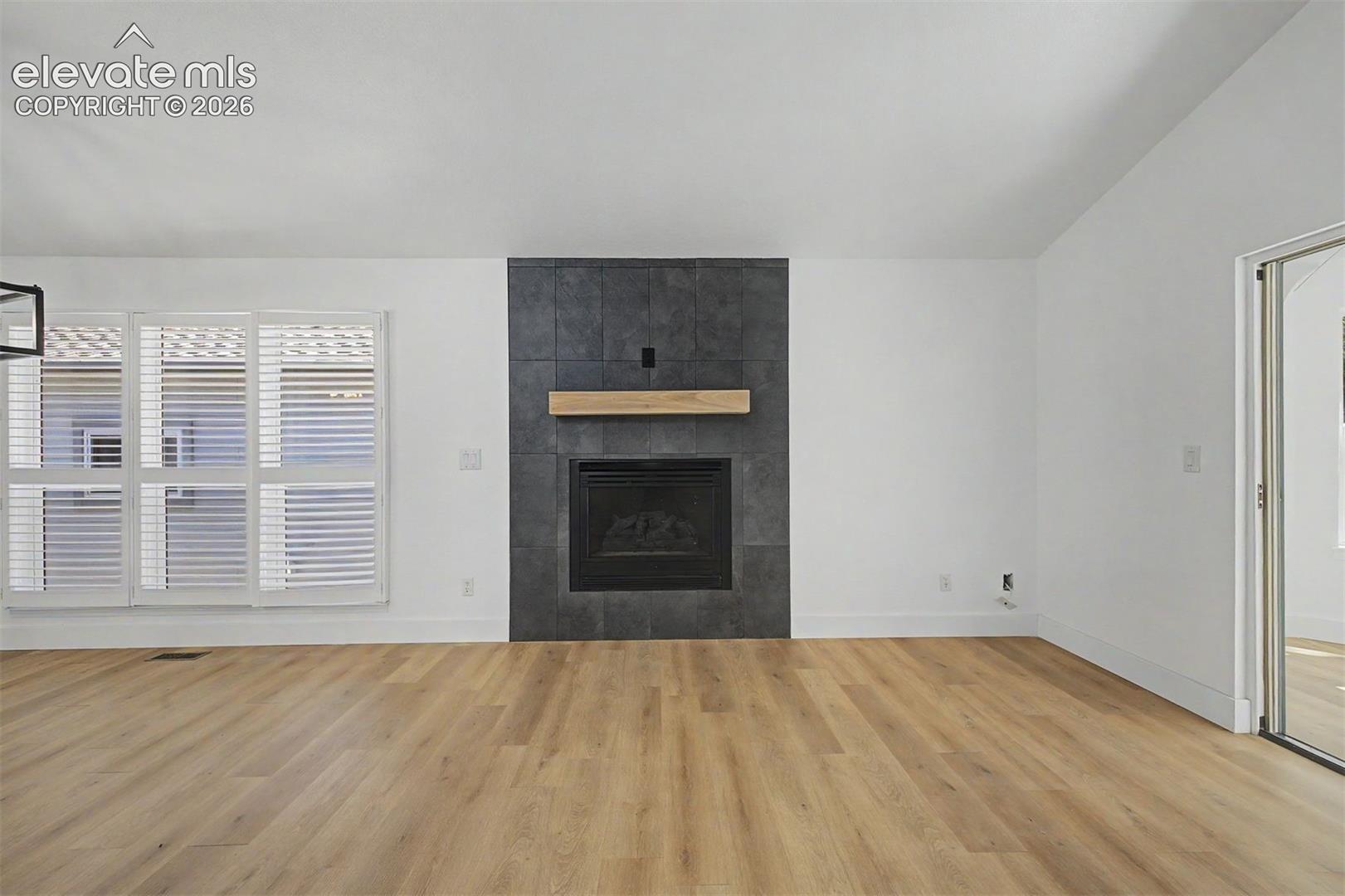 Living room with fireplace and attached sunroom