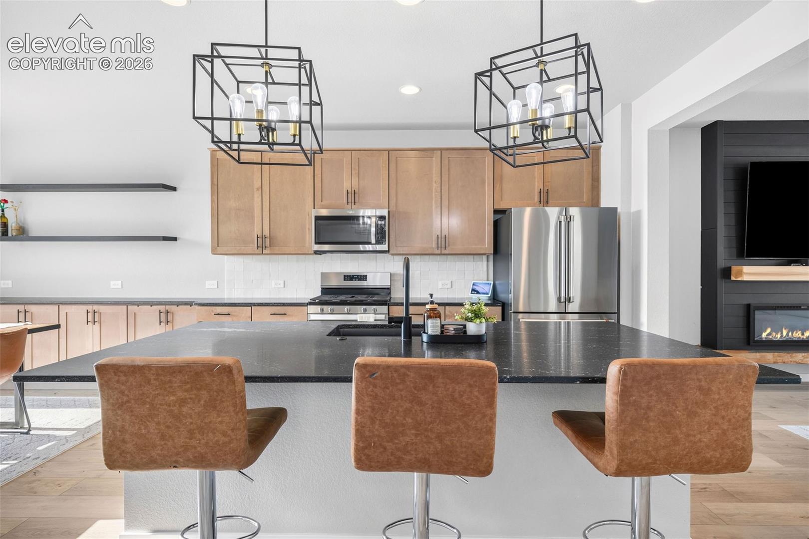 The maple-toned cabinetry carries from the kitchen into the dining area for extra storage and serving space. Upgraded lighting, leathered granite countertops and a pull-down faucet are all about style and function. Lots of upgrades in this home that you don't normally find at this price. 