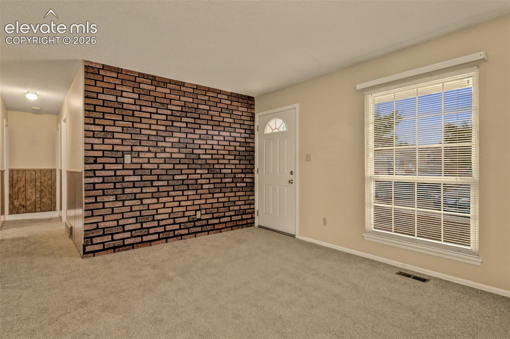 Nice size living room with brick wall
