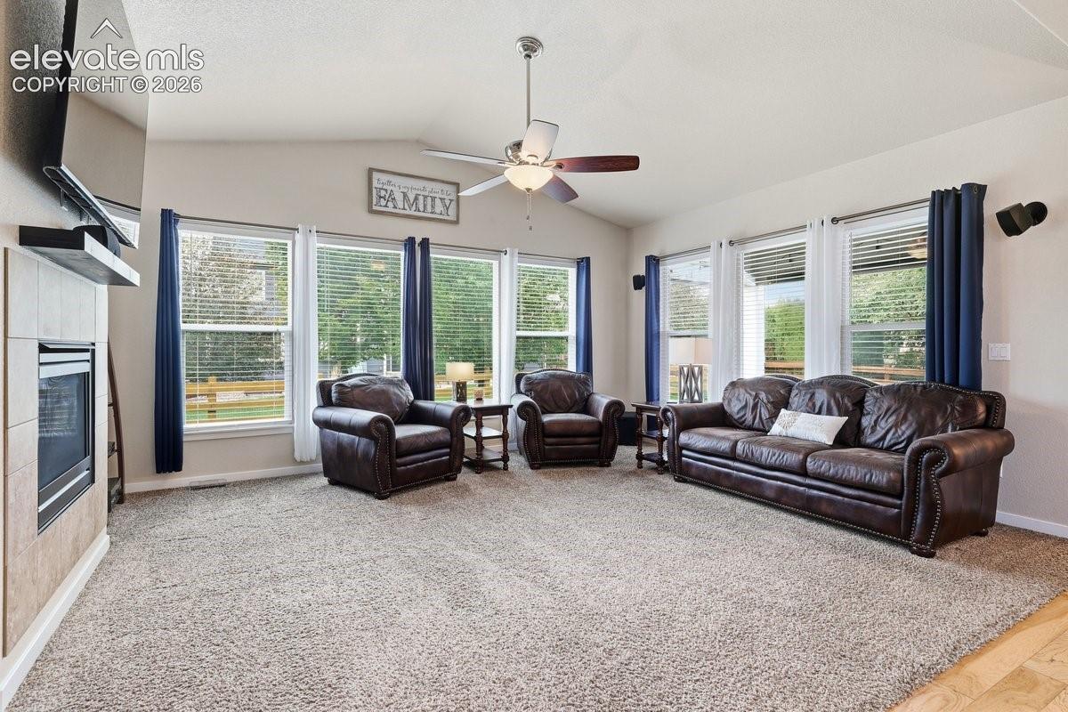 vaulted ceiling, gas fireplace, and lots of natural light pours in